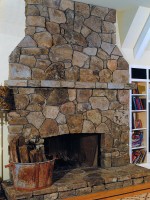 This rustic fireplace was designed and constructed for an addition to this country estate in Westport, CT. The fireplace, mantle and hearth were constructed of irregular shaped fieldstone, to match stonework at the residence and to achieve the effect of having been built at the same time as the original house. 