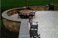 This sitting wall and terrace were designed and constructed for a client in Redding, CT. The fieldstone sitting wall was built in a Asher-Bond pattern. The 2” thick bluestone coping with rock-face that tops the sitting wall gives the area a sophisticated and finished look. Light grey pavers were utilized as the patio surface. 