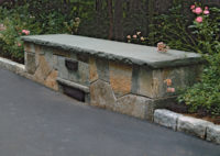 This driveway bridge in Old Greenwich, CT was constructed with low fieldstone side walls, capped by rockface bluestone. Weep holes at the base of the wall allow water to drain efficiently to the stream below.