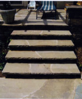 This inviting set of steps created for a client in Westport, CT were constructed to compliment the terrace of irregular shaped fieldstone. Notice how the steps mimic the irregular stone of the terrace. The rock face of the treads completes the look.